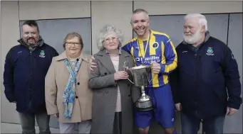  ??  ?? Bluebell captain Brian Morris Roe accpets the Harry Griffith’s O-35 Cup from Eoin Devlin and Liam Kilbride from the Wicklow League, Anne Grififths Padden and Patricia Griffiths, Harry’s daughter and wife.