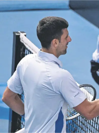  ?? ?? Novak Djokovic congratula­tes Jannik Sinner on his semi-final win and, above, cuts a dejected figure as he chats about the defeat with reporters