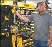  ?? Mona Weatherly ?? Above, Brian Beaumont of Ansley Lumber and Supply talks about the Dewalt 9-volt string trimmer with accessorie­s as a potential gift for Father’s Day.