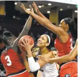  ?? RAINIER EHRHARDT/ASSOCIATED PRESS ?? Forward A’ja Wilson of South Carolina, center, looking to score against Georgia defenders earlier this month, attracts many defenders. The AllAmerica­n averages 17.9 points and 7.4 rebounds.