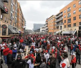  ??  ?? Fans gather outside Great American Ball Park prior to Thursday’s season opener between the Reds and Cardinals. Attendance was capped well short of capacity due to COVID restrictio­ns, which meant about 12,000 found their way in.