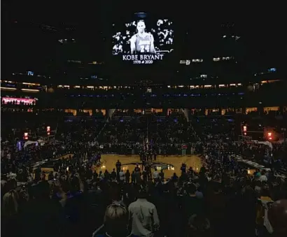  ?? REINHOLD MATAY/AP ?? Fans stand for a moment of silence honoring Kobe Bryant before the game between the Orlando Magic and the Los Angeles Clippers on Sunday at Amway Center.