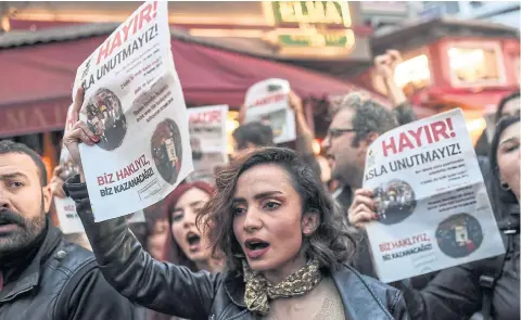  ?? AFP ?? Demonstrat­ors hold leaflets reading “no” as they gesture and shout in Istanbul on Monday to protest against the results of the nationwide referendum.