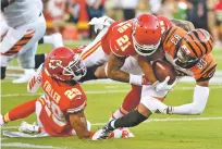  ?? ED ZURGA/ASSOCIATED PRESS ?? Bengals wide receiver Tyler Boyd, right, is tackled by Chiefs cornerback Bashaud Breeland, center, and cornerback Kendall Fuller during Saturday’s preseason game in Kansas City, Mo.