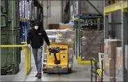  ??  ?? An employee at Helping Harvest walks down the aisle in the warehouse with a pallet of food. At the Berks / Schuylkill Helping Harvest Fresh Food Bank in Spring Township Wednesday morning January 20, 2021 where Claire Babineaux-Fontenot, the CEO of Feeding America. Helping Harvest is a member of Feeding America.