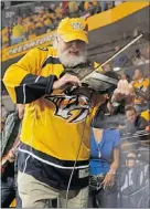  ??  ?? Country music star Charlie Daniels performs during an intermissi­on Wednesday night at Nashville’s Bridgeston­e Arena.