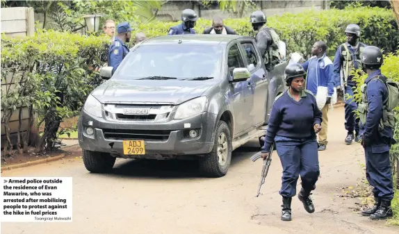  ?? Tsvangiray­i Mukwazhi ?? Armed police outside the residence of Evan Mawarire, who was arrested after mobilising people to protest against the hike in fuel prices