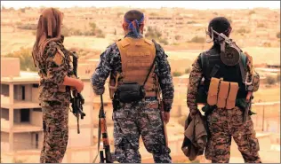  ?? Pictures: AP ?? THE LIBERATORS? This picture, provided by the Syrian Democratic Forces, shows some of their fighters. Syrian government and allied troops have inserted themselves into the battle against Islamic State militants by capturing key areas on the flanks of...