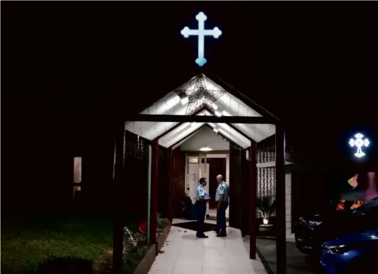  ?? MARK BAKER/ASSOCIATED PRESS ?? Security officers stood guard outside the Orthodox Assyrian church in Sydney, Australia, on Monday.