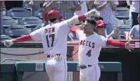  ??  ?? The Angels’ Shohei Ohtani, left, is greeted by Jose Iglesias after hitting a solo home run during the fifth inning Wednesday.