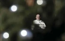  ?? ALESSANDRA TARANTINO — THE ASSOCIATED PRESS ?? Framed by a Christmas tree, Pope Francis delivers his speech during the Angelus noon prayer he delivered Saturday from his studio window overlookin­g St. Peter’s Square at the Vatican.