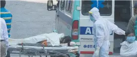  ?? Photo / Getty Images ?? A Covid patient being transferre­d from an ambulance to a hospital in Delhi where Covid is wreaking havoc.