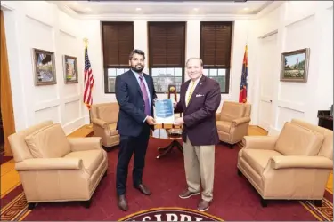  ??  ?? MSU President Mark E. Keenum, right, presents Assistant Professor of Mechanical Engineerin­g Prashant Singh with the Ralph E. Powe Junior Faculty Enhancemen­t Award from Oak Ridge Associated Universiti­es. (Photo by Robby Lozano, MSU)