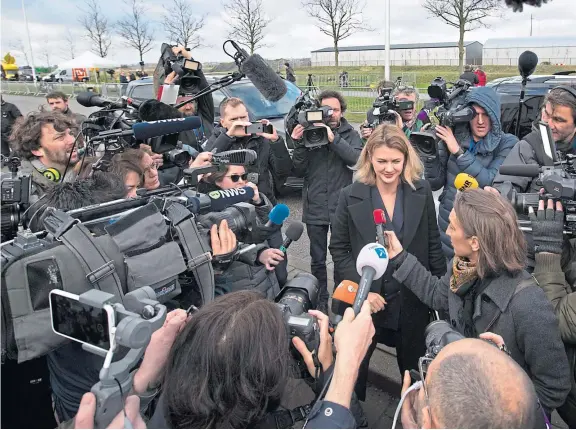  ??  ?? Journalist­s crowd around members of the Ukrainian delegation outside the court where the trial, at Schiphol, opened yesterday.