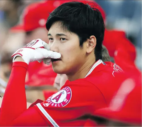  ?? GETTY IMAGES ?? Shohei Ohtani of the Los Angeles Angels watches the action from the dugout during a recent game against the Kansas City Royals. Ohtani is proving to be a modern Babe Ruth. He’s 2-0 as a starting pitcher with a 2.08 ERA while hitting .367 with three...