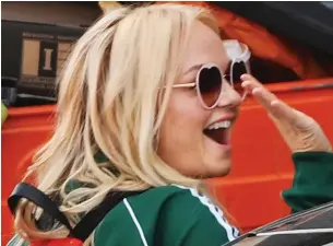  ??  ?? Ready for work: Emma Bunton in green tracksuit waves to fans