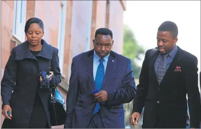  ??  ?? ON TRIAL: Former lecturer and now church leader Walter Masocha, centre, arrives at Falkirk Sheriff Court. He denies the charges against him.