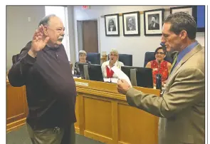  ?? NWA Democrat-Gazette/TOM SISSOM ?? Mike Jeffcoat is sworn in Thursday as a Benton County justice of the peace by Circuit Judge Brad Karren in Bentonvill­e.