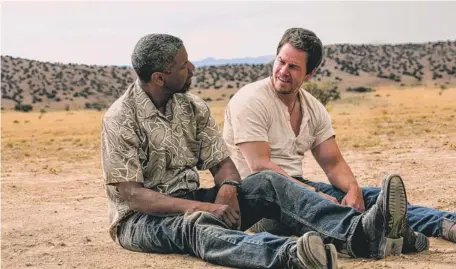  ??  ?? Bobby (Denzel Washington) and Stig (Mark Wahlberg), undercover agents for different agencies, team up after they become the targets in the caper movie “2 Guns.”