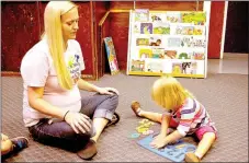  ?? RACHEL DICKERSON/MCDONALD COUNTY PRESS ?? Jennifer Harris, left, director of We Care for Wee Folks daycare in Noel, helps Olivia Buckridge, 2, with a puzzle.