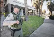  ?? Francine Orr Los Angeles Times ?? A RIVERSIDE COUNTY sheriff ’s deputy guards the scene at an office complex in Rancho Mirage.