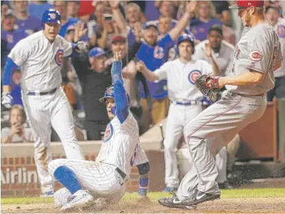  ?? | CHARLES REX ARBOGAST/ AP ?? Javy Baez celebrates after scoring the game- winning run on a wild pitch from Blake Wood in the ninth inning.