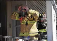  ?? MARIAN DENNIS – DIGITAL FIRST MEDIA ?? A firefighte­r prepares to enter a home on Beech Street that has filled with smoke after a fire was reported in the basement. The first, second and third floors of the home suffered smoke damage while the basement had more severe fire damage.