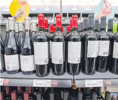  ?? RYAN REMIORZ / THE CANADIAN PRESS ?? As a way to illustrate their displeasur­e with stalled contract negotiatio­ns, unionized workers at some Société des alcools du Québec locations have spun bottles around on the shelves, making it tougher to find products.