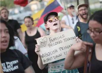  ?? SCOTT OLSON/ GETTY IMAGES ?? Demonstrat­ors hold a rally in the Little Village neighborho­od calling for the eliminatio­n of U. S. Immigratio­n and Customs Enforcemen­t ( ICE) and an end to family detentions last week in Chicago.