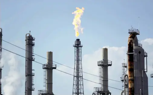  ??  ?? A flame burns at the Shell Deer Park oil refinery in Deer Park, Texas. (AP)