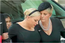  ?? — AFP ?? Meghan McCain and her mother Cindy McCain embrace as the casket of the late Senator John McCain arrives at the Washington National Cathedral for the funeral service on Saturday.