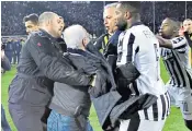  ??  ?? Ivan Savvidis came on to the field twice during a match between PAOK and AEK Athens. On the second occasion, without his overcoat, Savvidis was seen to be carrying a pistol in its holster