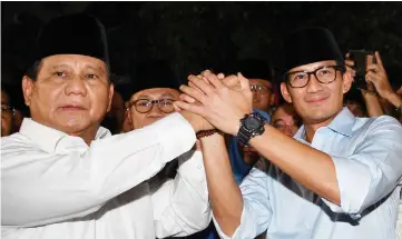  ??  ?? Prabowo (left) and Sandiaga Uno announce their bid in the 2019 presidenti­al elections. —Reuters photos