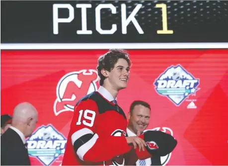  ?? BRUCE BENNETT/GETTY IMAGES ?? Jack Hughes smiles after being chosen first overall by the New Jersey Devils during the NHL Entry Draft at Rogers Arena on Friday in Vancouver. The centre is one of seven players from the U.S. National Team Developmen­t Program who were among the first 15 picks.