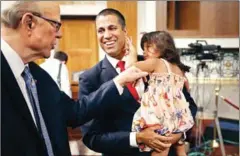  ?? CHIP SOMODEVILL­A/AFP ?? FCC Chairman Ajit Pai (centre) holds his daughter Annabelle while visiting with US Senator Pat Roberts.