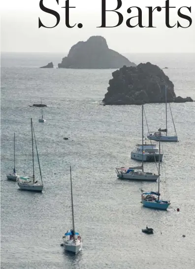  ?? ALAN BEHR/TRIBUNE NEWS SERVICE ?? Pleasure boats sit anchored outside Gustavia, the capital of St. Barts, as the sun goes down.