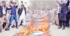  ??  ?? Pakistani Kashmiri lawyers shout slogans beside a burning effigy of Modi during a protest in Muzaffarab­ad, the capital of Pakistan-controlled Kashmir.