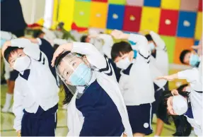  ?? Photo: Sam Tsang ?? Children take part in stretching exercises at a kindergart­en in Tai Po yesterday.