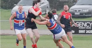  ??  ?? Bunyip’s Nathan Lieshout lays a tackle on Koo wee rup’s Liam Hetheringt­on; Photograph­s: Michael Robinson.