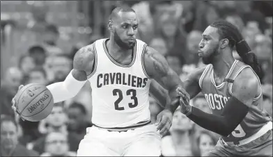  ?? Associated Press ?? Defense: Cleveland's LeBron James (23) looks to drive against Boston's Jae Crowder (99) during the first half of Game 3 of the Eastern Conference finals on Sunday in Cleveland.