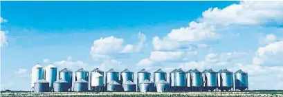  ?? PHOTOS COURTESY OF JESSE MICAK ?? Blue skies and grain silos in Saskatchew­an, one of Jesse Micak’s favourite photos en route his solo cross-country bike ride.