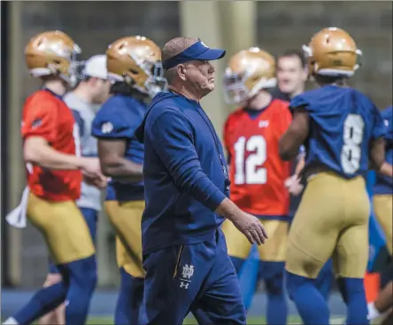  ?? ROBERT FRANKLIN ?? FILE - In this March 2, 2019, file photo, Notre Dame coach Brian Kelly walks on the field during the NCAA college football team’s spring practice in South Bend, Ind. The NCAA’S football oversight committee expects to finalize a plan on Thursday to allow teams to conduct up to 12 unpadded, slow-speed practices, also know as walk-throughs, during the 14 days before the typical preseason begins in August. Kelly said the extra time on the field with a ball will be valuable for teaching schemes, but not necessaril­y for assessing player developmen­t.