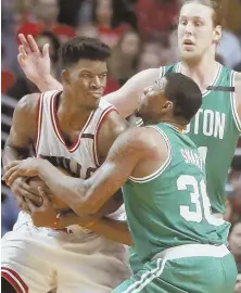  ?? AP PHOTO ?? HANDS-ON: Kelly Olynyk watches as Marcus Smart tries to rip the ball away from Jimmy Butler.