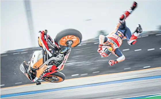  ??  ?? Honda’s Marc Marquez crashes during yesterday’s first practice session at the Thailand Grand Prix in Buri Ram.