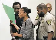  ?? AP/Atlanta Journal-Constituti­on/HENRY P. TAYLOR ?? Basil Eleby is escorted by his public defender and two sheriff’s deputies into the courtroom Saturday at the Fulton County jail in Atlanta.