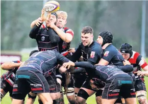  ??  ?? Challenge
Andrew Davidson fights to win the ball for County