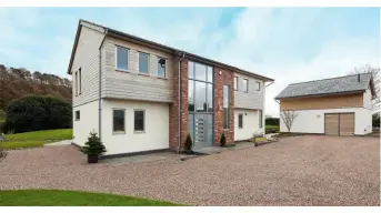  ??  ?? Above: Nigel and Louise specified a Sandstone tier panel system to tie in with the local landscape. This is complement­ed by cedar cladding and silicone render