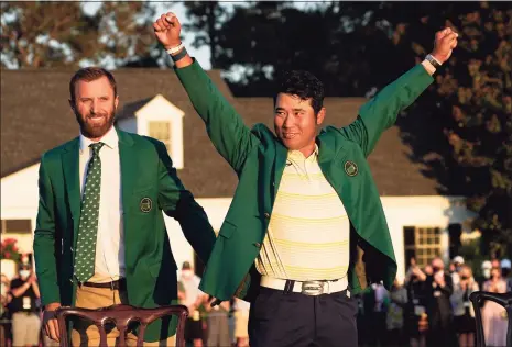  ?? David J. Phillip / Associated Press ?? Hideki Matsuyama, right, celebrates with the green jacket after winning the Masters as last year’s champion Dustin Johnson watches on Sunday in Augusta, Ga.