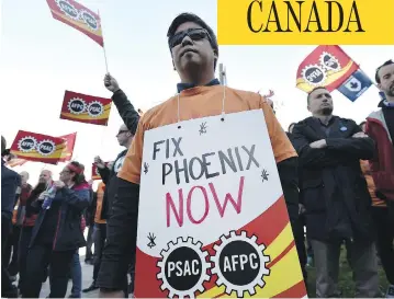  ?? JUSTIN TANG / THE CANADIAN PRESS ?? Public servants protest over glitches with the troubled Phoenix pay system in Ottawa in October. Introduced by the Liberal government in February 2016, the centralize­d remunerati­on program immediatel­y ran into difficulti­es.