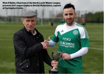  ??  ?? Mick O’Reilly, Chairman of the North Louth Winter League, presents the League trophy to Declan McGuinness, captain of Carlingfor­d Celtic.